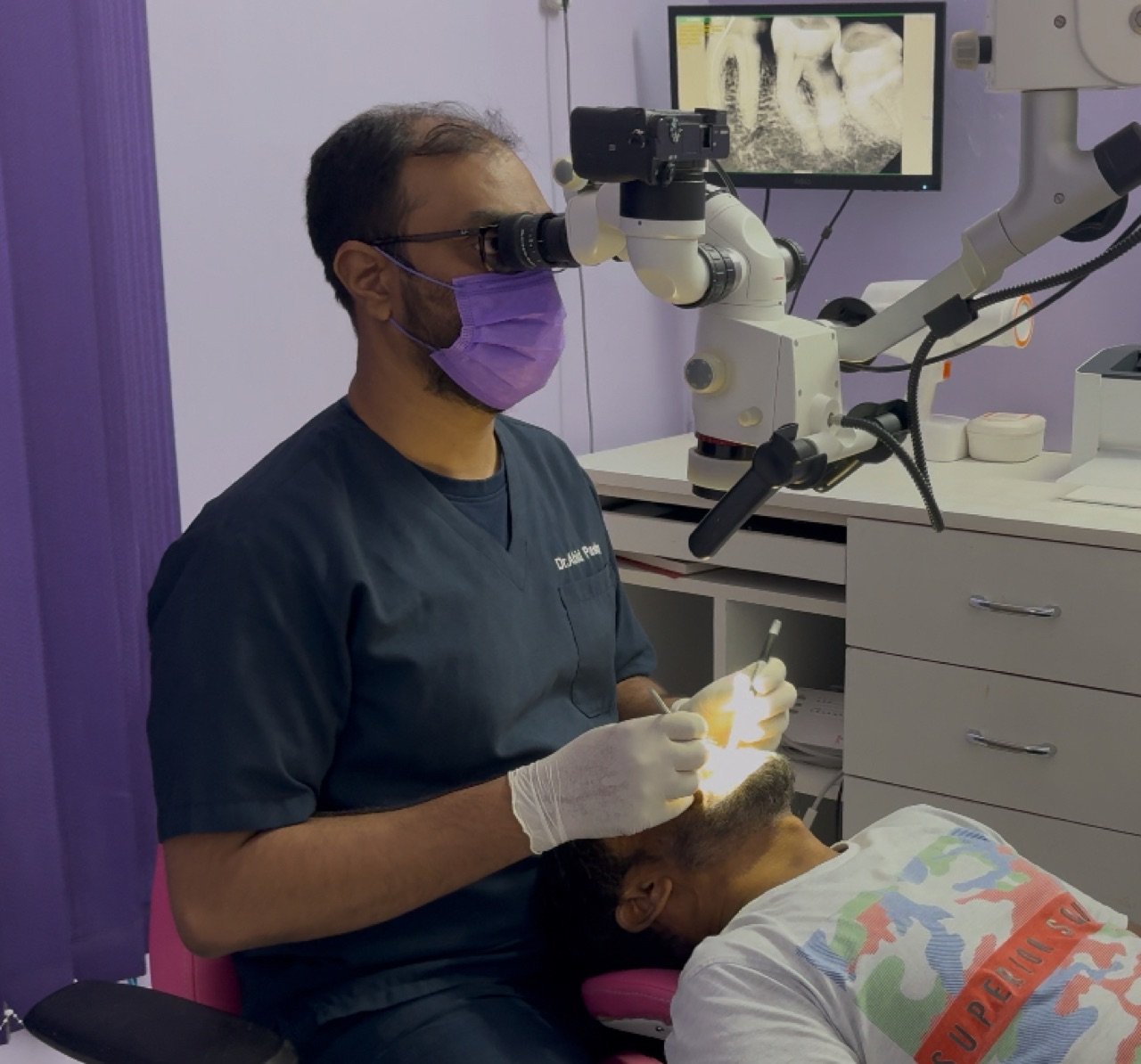 Dr. Abid Pasha at work under the dental operating microscope